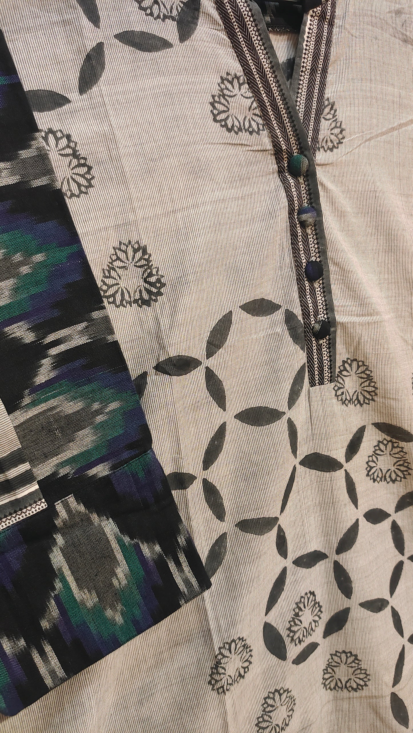 Textile with geometric pattern and colorful accents on a neutral background
