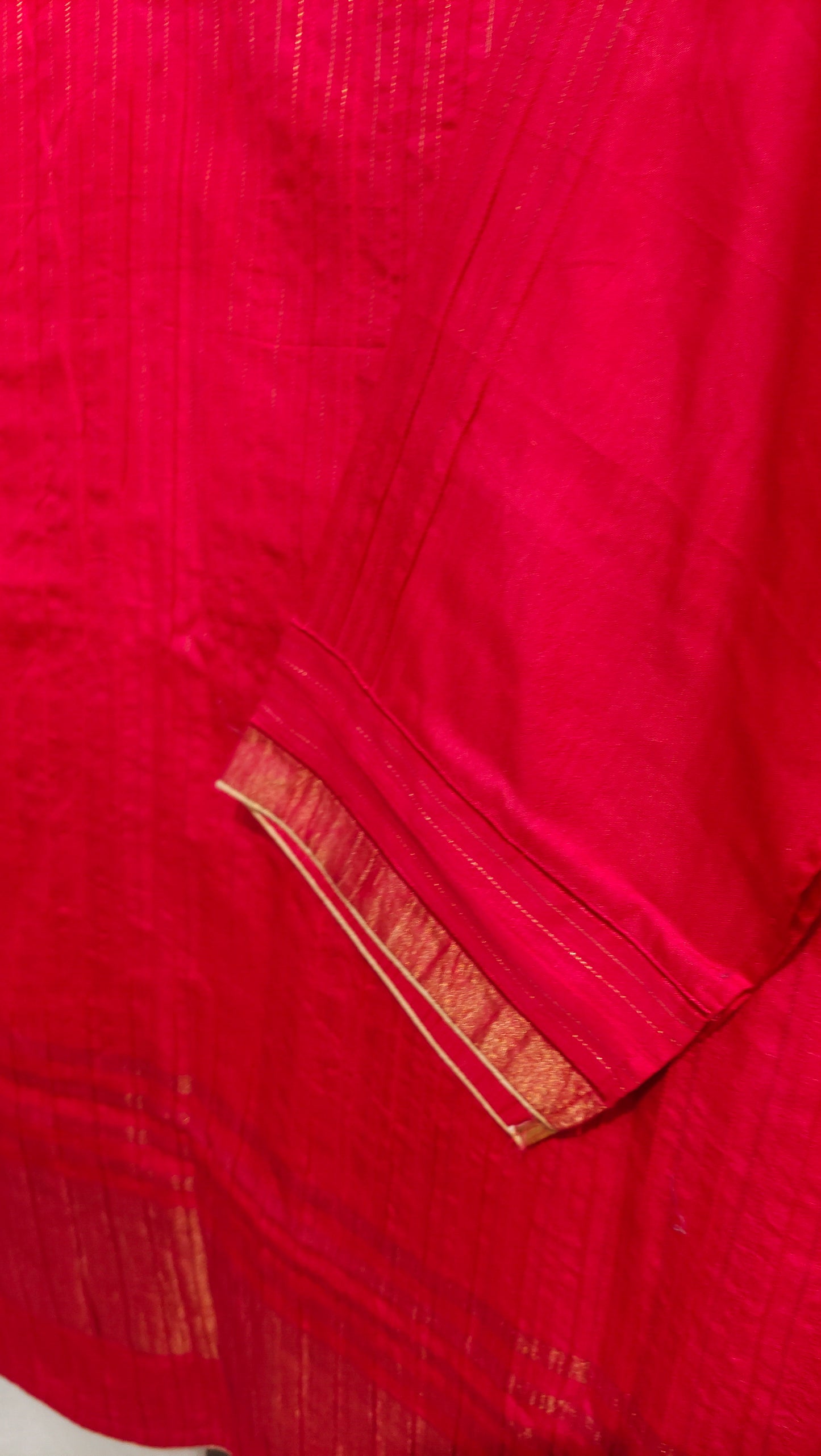 Close-up of a red fabric with gold border