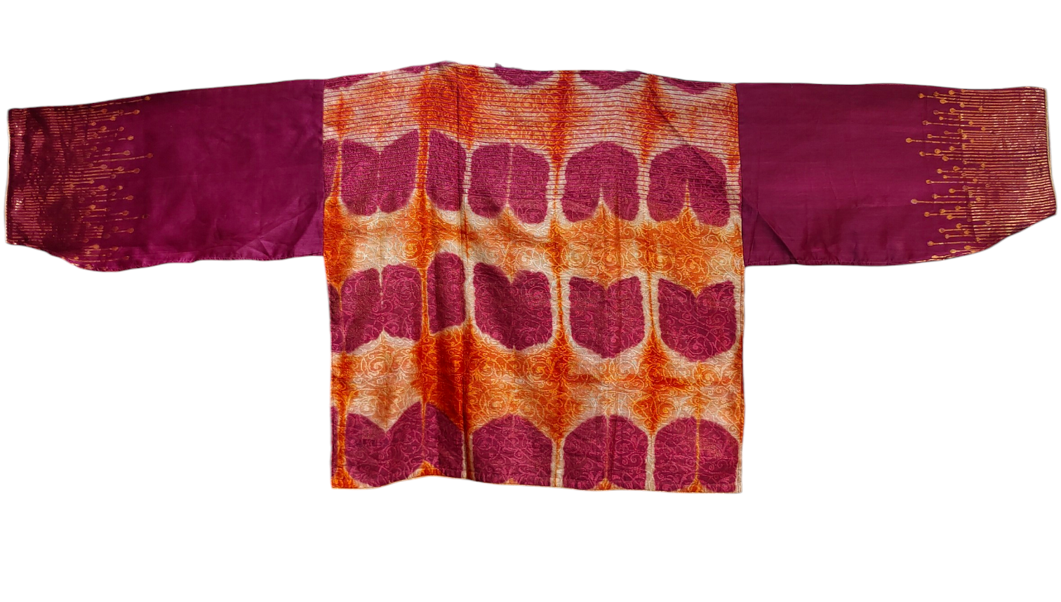 Traditional fabric a patterned back and solid sleeves on a white background