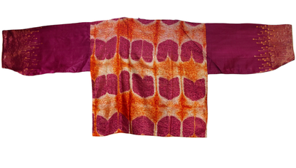 Traditional fabric a patterned back and solid sleeves on a white background