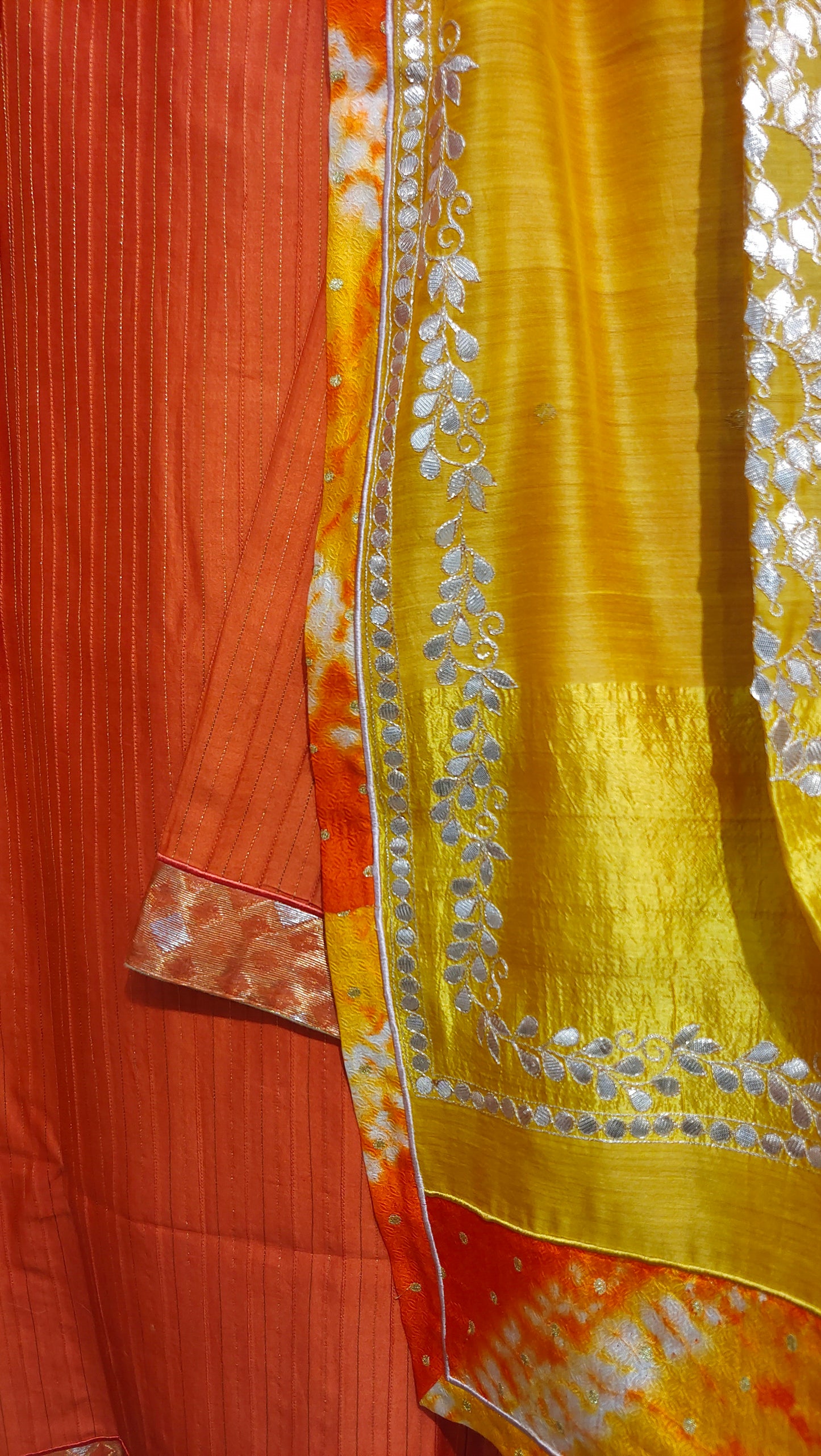 Yellow kurta with silver embroidery on a red background