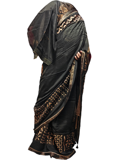 Black saree with gold patterns on a white background