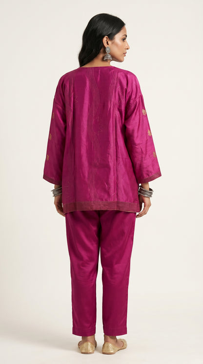 Woman wearing a pink traditional outfit on a white background