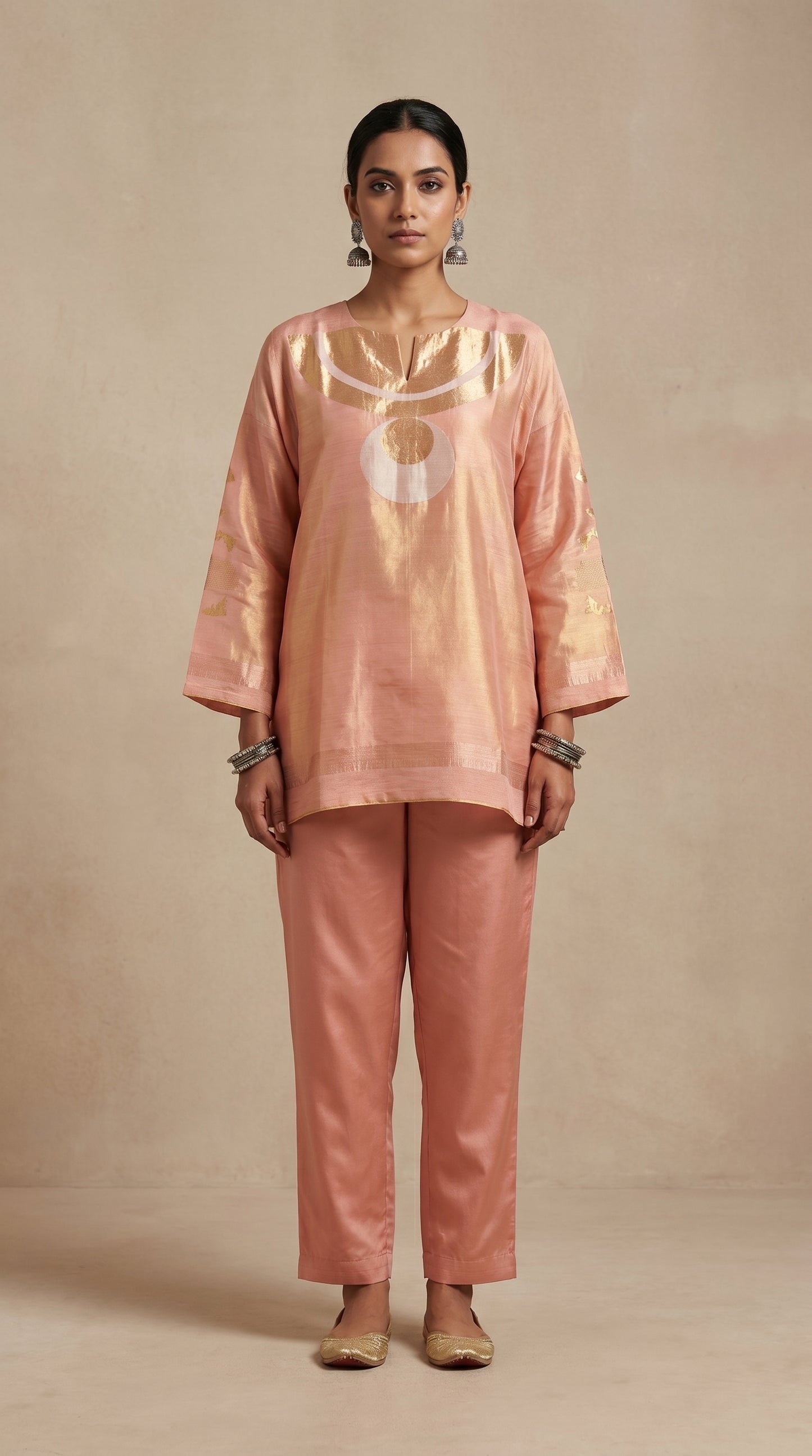 Woman wearing a pink traditional outfit against a beige background
