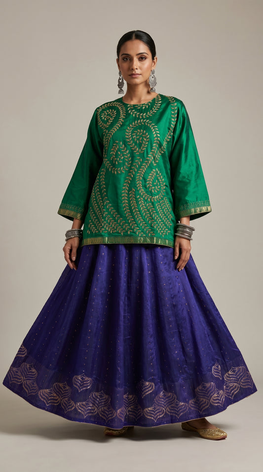 Woman wearing a green embroidered top and purple skirt on a beige background