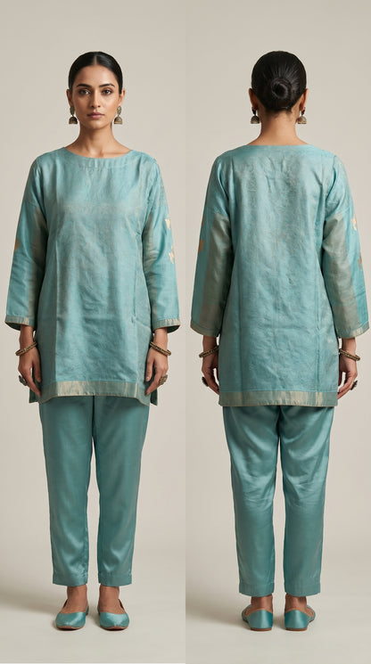 Woman wearing a teal traditional outfit with front and back views on a plain background