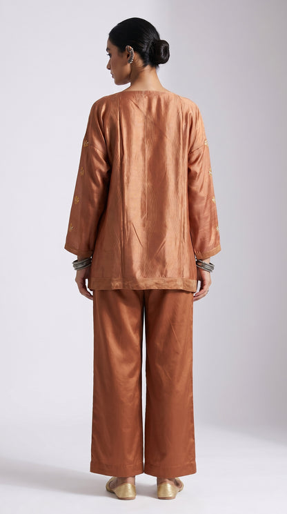 Woman wearing a brown outfit on a white background