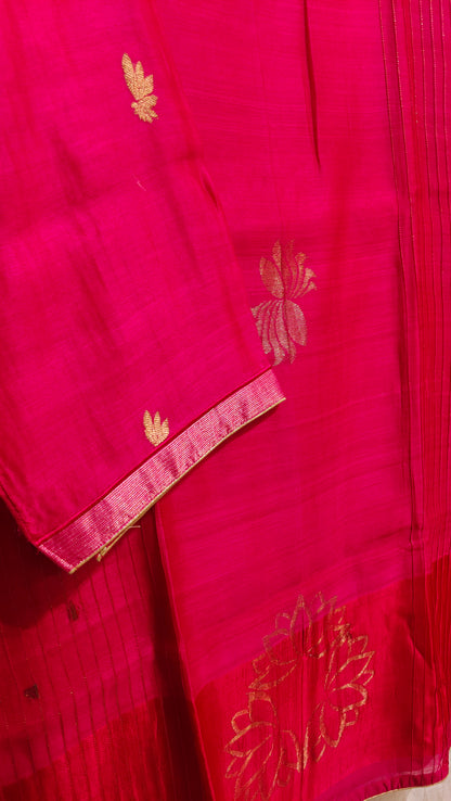 Red fabric with gold embroidery on a plain background