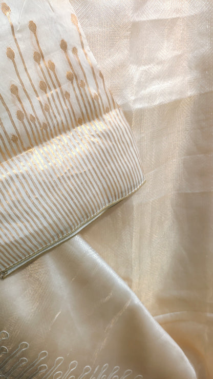 Close-up of beige fabric with subtle patterns and a comb.