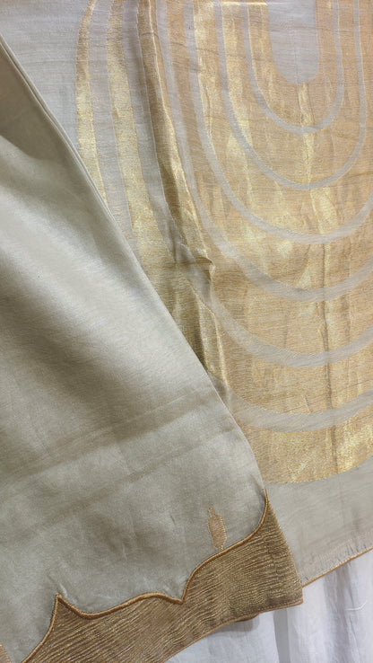 Close-up of beige fabric with circular patterns on a white background