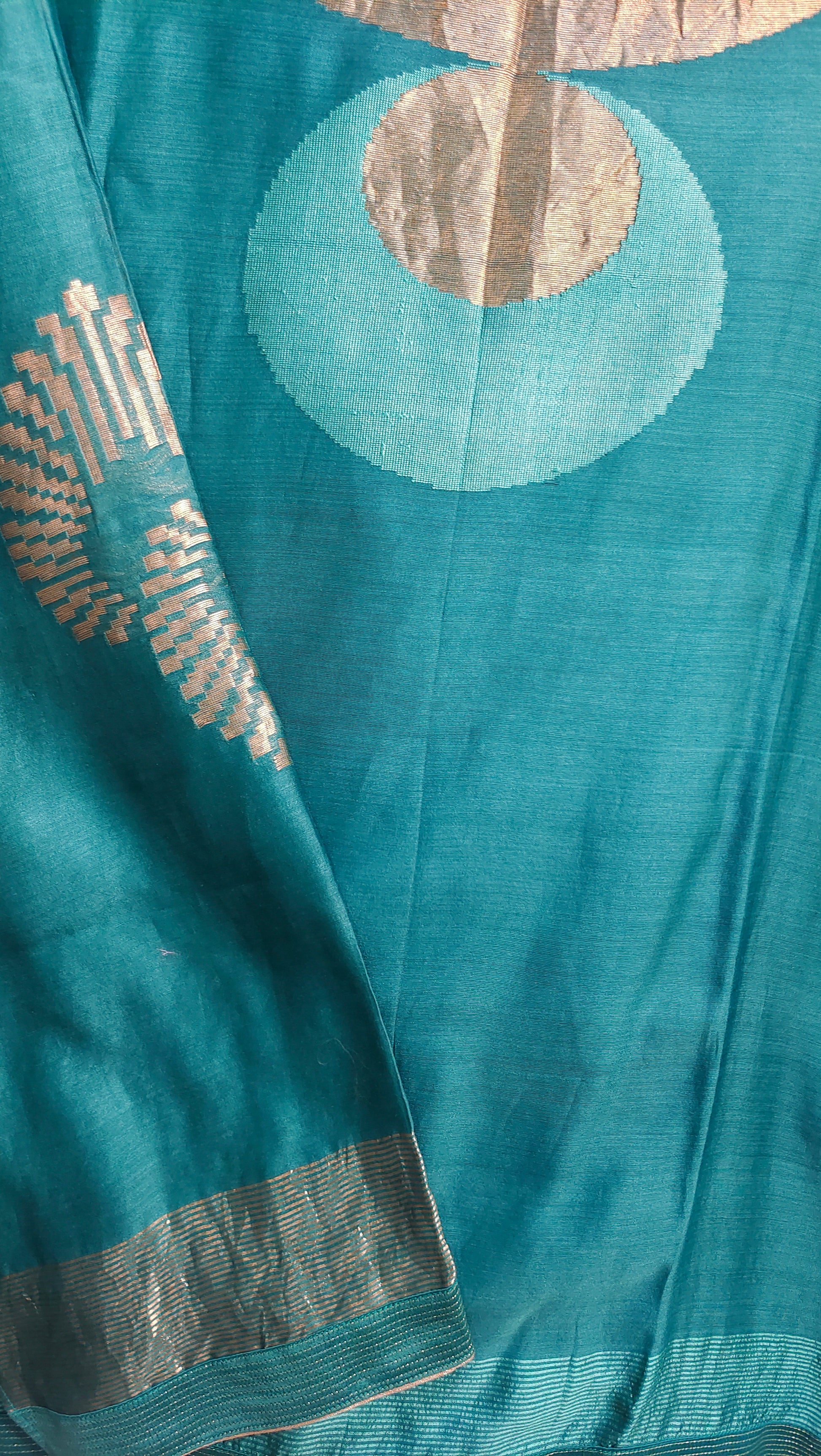 Teal fabric with gold embroidery and patterns