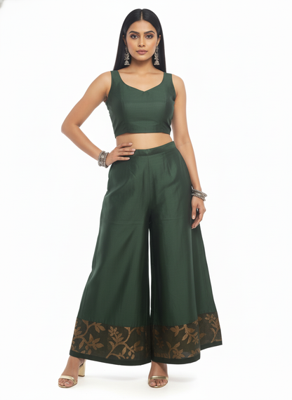 Woman wearing a green plazzo pant on a white background